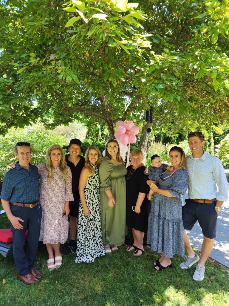 The Hanmer family gathered outdoors under a tree